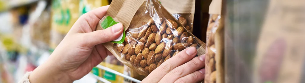 Person Getting Healthy Gas Station Snacks Nuts off Kelley's Market Shelf