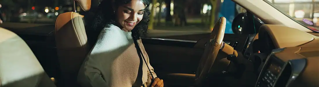 woman putting seatbelt on going to a grocery store open late near me
